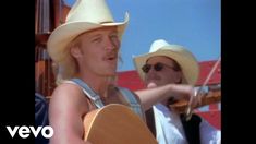 two women wearing cowboy hats and holding guitars