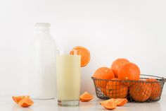 oranges and a glass of milk on a table