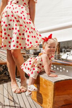 Get ready to cherry pick your little one's outfit with the Baby June Skirt Romper! Made from cream and red cherry print cotton fabric, this romper features a high neckline with a rounded collar and functional buttons on the back. With a knee-length skirt and pockets, this romper keeps it playful with a lined bodice and non-stretch fabric. Perfect for any occasion! Available in sizes 0-3 months, 3-6 months, 6-9 months, + 9-12 months!! summer romper, baby outfit, matching mom and kid outfit Playful Fitted Red Bubble Romper, Family Matching Cotton Bubble Romper For Spring, Fitted Red Bubble Romper For Summer, Red Fitted Bubble Romper For Summer, Red Bubble Romper For Summer Playwear, Summer Red Bubble Romper For Playwear, Fitted Cotton Bubble Romper For Playdate, Cute Red Bubble Romper For Spring, Cute Red Cotton Bubble Romper