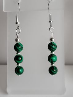 These round green Malachite gemstone earrings have Sterling Silver beads and findings. Some benefits associated with Malachite include providing protection, alleviating negativity, and physically helping to enhance your well-being improving your immune system, respiratory system, liver, and energy levels. Malachite gemstones displayed throughout your home or safely tucked away, allows you to be able to reap some of these additional benefits. Custom orders are always welcome! Spiritual Green Gemstone Earrings, Green Spiritual Earrings With Natural Stones, Spiritual Green Earrings With Natural Stones, Green Spiritual Earrings For Healing, Spiritual Round Hypoallergenic Earrings, Hypoallergenic Round Spiritual Earrings, Spiritual Hypoallergenic Round Earrings, Green Gemstone Round Bead Earrings, Green Gemstone Earrings With Round Beads