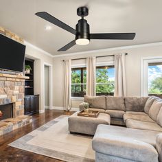 a living room with a couch, fireplace and television