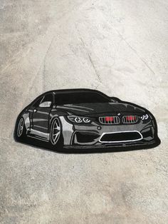 a black and white drawing of a sports car on the ground with its hood up