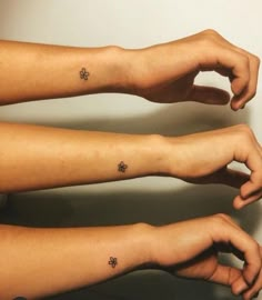 two people with matching tattoos on their arms