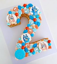 the number two is made out of cookies and decorated with cartoon character characters on it