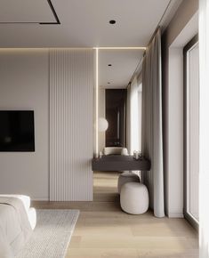 a modern bedroom with white walls and wood flooring, along with a large television mounted on the wall