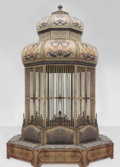 an antique birdcage with ornate carvings on it