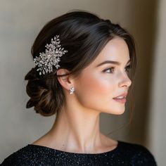 This elegant bridal updo features a low, voluminous bun adorned with a sparkling crystal hairpiece, perfect for adding a touch of glamour to your wedding day look. The delicate side-swept hair and soft makeup create a timeless and sophisticated style that complements any bride's vision. Ideal for weddings, proms, or any special occasion where you want to feel effortlessly chic. Side Part Wedding Updo, Updo With Blusher Veil, Bridal Hair Side Bun, Side Part Wedding Hair Updo, Bridal Updo Strapless Dress, Wedding Updo With Headband, Side Bun Hairstyles Wedding, Elegant Bun Hairstyles Classy, Low Side Bun Wedding Hair