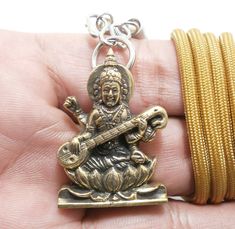 Saraswati Hindu Goddess Amulet Pendant Size : 2.5 x 3.4 cm. (Approx.) This is Saraswati Hindu Goddess amulet.This is the amulet for  Bring Wisdom,Healing, Success, Good Luck. Saraswati (Sanskrit: सरस्वती, Sarasvatī) is the Hindu goddess of knowledge, music, art, wisdom and learning worshipped throughout Nepal and India.[3] She is a part of the trinity (Tridevi) of Saraswati, Lakshmi and Parvati. All the three forms help the trinity of Brahma, Vishnu and Shiva to create, maintain and regenerate-r Symbolic Jewelry For Navratri Rituals, Adjustable Spiritual Jewelry For Diwali, Navratri Brass Jewelry Gift, Adjustable Necklace For Diwali Gift, Adjustable Necklaces For Diwali Gift, Spiritual Locket Necklace For Navratri, Spiritual Adjustable Jewelry For Navratri, Spiritual Locket Jewelry For Navratri, Adjustable Spiritual Jewelry For Navratri