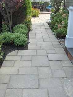 a brick walkway in front of a house