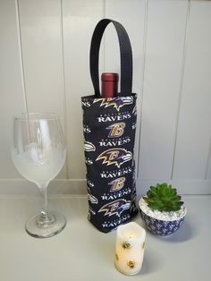 a wine bottle bag sitting next to a candle