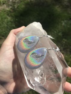 These holographic Teardrop geode earrings made from resin shift from clear to a beautiful sparkly rainbow. They are lightweight and won't bother your ears. Made by Katie Glover Resin Art by Katie 2020 Contact me on my Instagram @123pour if you would like additional photos or videos of this product.Please be aware that this is handmade art and perfection has no place in art. However, this was crafted with love and intention and I hope you are satisfied with your purchase. Your purchase is not ref Iridescent Hypoallergenic Drop Earrings, Nickel-free Iridescent Crystal Earrings For Party, Iridescent Teardrop Hypoallergenic Jewelry, Iridescent Pierced Drop Earrings, Iridescent Crystal Earrings For Gift, Unique Iridescent Teardrop Earrings, Pierced Iridescent Jewelry For Party, Iridescent Pierced Jewelry For Party, Iridescent Hypoallergenic Earrings For Party