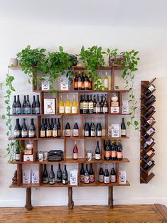 a wine rack filled with lots of bottles next to a wall mounted shelf full of wines