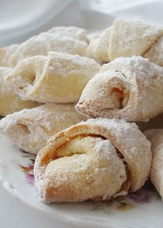 powdered sugar filled pastries on a plate