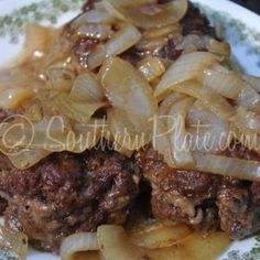 a close up of a plate of food with meat and onions