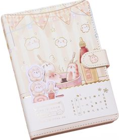 an open planner book with some stickers on it's cover and two bears in the background