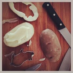 an assortment of food on a cutting board next to a knife