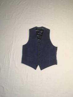 "vintage 1970s men's waistcoat vest smokey blue corduroy front braided black buttons 4 pocket front blue acetate feel backing corduroy feels cotton, might have a blend of small amount of synthetic double v front hem straight hem back back waist sash good vintage condition, light wear, bottom button is decorative, doesn't lay properly buttoned labeled 42 Reg, see below measures, lying flat, shoulder-12\" chest-21\" waist-18 1/2\" hem-19\" length-27\"    All sales final, no returns/exchanges. Please feel free to contact us with any questions you may have about an item prior to purchase and we will gladly answer them." Formal Blue Vest With Buttons, Fitted Retro Vest With Button Closure, Retro Fitted Vest With Button Closure, Fitted Blue Vest With Buttons, Fitted Vintage Blue Vest, Navy Fitted Winter Vest, Navy Fitted Vest For Winter, Blue Fitted Vintage Vest, Navy Fitted Vest For Fall