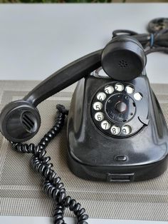 an old fashioned telephone sitting on top of a table