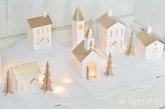 small white and gold christmas village with lights