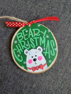 a christmas ornament with a bear wearing a bow tie and the words beard christmas on it