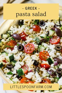 greek pasta salad in a bowl with olives, tomatoes, cucumbers and feta cheese