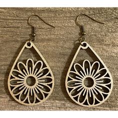 the earrings are made out of wood and have an intricate design