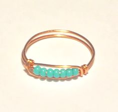 Made with Turquoise glass seed beads Comes with approximately 6 beads unless you specify a different quantity The band is tarnish-resistant plated wire in your choice of finish Turquoise Beaded Rings As Gifts, Turquoise Beaded Rings As A Gift, Ring With Gold Band, Sea Glass Ring, Worry Ring, Jasper Ring, Fidget Rings, Silver Spinner Rings, Turquoise Glass