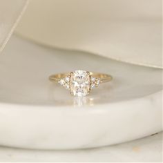 a diamond ring sitting on top of a white cloth