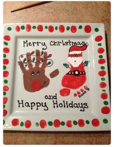 a christmas plate with santa and reindeer handprints on it