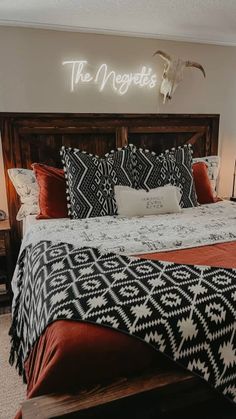 a bed with black and white bedspread in a bedroom