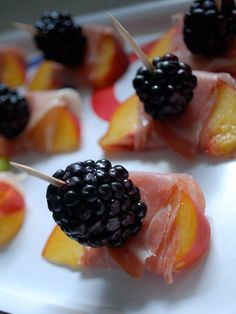 some fruit on sticks with blackberries and peaches