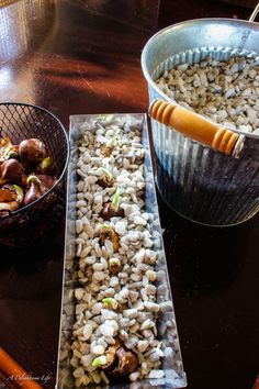 there are two metal pans with food in them on the table next to each other