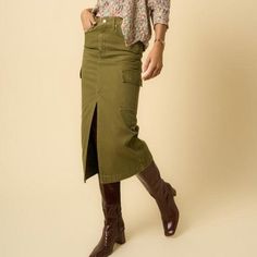 Introducing our Olive Cargo Midi Skirt, a must-have for those who appreciate the blend of functionality and style. This skirt is crafted from 100% cotton, ensuring breathability and comfort throughout the day. It features a practical front zipper fly for ease of wear and multiple pockets that not only add a utilitarian touch but also enhance its overall aesthetic. Presented in a rich, true olive color, this cargo skirt offers a versatile look that can be easily dressed up with a blouse and heels Fall Cotton Cargo Skirt With Relaxed Fit, Long Cotton Cargo Skirt With Lining, Cotton Long Cargo Skirt With Lining, Green Utility Mini Skirt, Long Cotton Cargo Skirt With Side Pockets, Green Cotton Skirt With Pockets, Fall Long Khaki Skirt, Relaxed Khaki Skirt For Fall, Khaki Midi Skirt For Fall