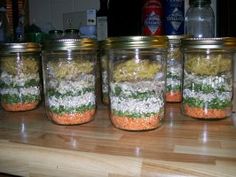 four mason jars filled with different types of food