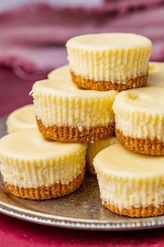 several mini cheesecakes are stacked on top of each other in a metal plate