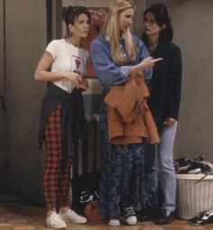 three women standing in front of a store