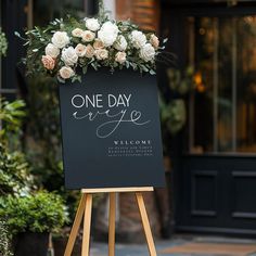 a sign with flowers on it that says one day everyone welcomes us to our guests