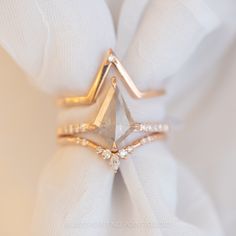 a diamond ring sitting on top of a white napkin