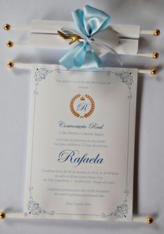 a blue ribbon is tied around the front of a white card with a gold ring on it