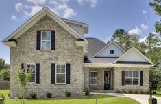 a brick house with white trim and black shutters