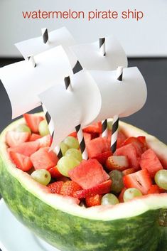 watermelon pirate ship cut into pieces with strawberries and grapes in the center