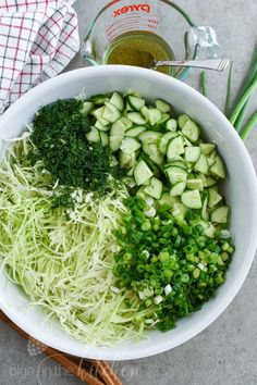 a bowl filled with cucumbers and green onions