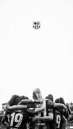 a group of young women standing next to each other on top of a soccer field