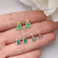 Fun set of Christmas tree stud earrings in high quality 925 sterling silver. Earrings are perfect for any age. Metal: 925 Sterling silver ( 925 stamped )  Measurements : Tree 1: 9mm x 10mm. Tree 2: 7mm x 8mm. Tree 3: 8mm x 8mm. These delicate stud earrings are handcrafted from 925 sterling silver, that doesn't tarnish their little ears hypoallergenic, nickel and lead free. ADD TO YOUR ORDER: 925 Sterling silver butterfly silicone coated backings link:  https://www.etsy.com/listing/1329998079/hypoallergenic-925-sterling-silver?click_key=4f118e1c6fc0ffc59ced3828b98795b9ea8b113d%3A1329998079&click_sum=de83cded&ref=shop_home_active_56&sts=1 PACKING: All jewelry is package already to be gifted. Just let me know if the gift is for a birthday, I will add some fun birthday confetti! Also you have Cheap Cute Christmas Earrings, Toddler Earrings, Earrings Kids, Simple Wedding Bouquets, Glitter Stud Earrings, Initial Earrings Studs, Stocking Stuffers For Girls, Tree Earrings, Christmas Tree Earrings