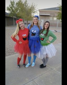 three girls dressed up in costumes standing next to each other