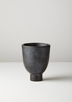 a black bowl sitting on top of a white table