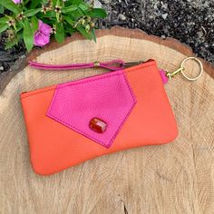 "Yummy Orange and Hot Pink Leather uniquely decorated with a Gemstone Agate Stone Bead. Minimalist Zip Wallet, Clutch or Glasses case ...lots of uses. The clip-on Key Ring means you can just grab it out of your purse, clip on the keys and go! Use it as Purse Organizer Bag or Makeup Bag. A unique Designer Bag, it is an excellent gift. Flat Zipper Bag with 1 section is 6 1/2\"wide by 4 \" deep. Only 3 made!" Adjustable Clutch With Removable Pouch For Gift, Clutch Pouch With Cell Phone Pocket For Gift, Cell Phone Pocket Clutch Pouch For Gift, Rectangular Clutch With Cell Phone Pocket As Gift, Gift Wallets With Cell Phone Pocket In Clutch Shape, Gift Clutch With Interior Key Chain Holder, Orange Pouch Clutch As Gift, Pink Coin Purse With Cell Phone Pocket For Gift, Orange Pouch Clutch For Gift