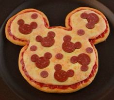 a mickey mouse pizza with pepperoni and cheese