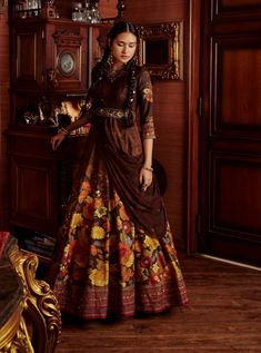 Editor's Note Featuring a hand painted and printed floral design anarkali, styled with a coordinated design border dupatta adorned with beads and sequins and stylised with a hand embroidered belt. Fabric: Anarkali: viscose silk, dupatta: georgette Color: Brown Components: Anarkali, belt and dupatta Occasion: Wedding Guest and festive Disclaimer: Product color may slightly vary due to photographic lighting sources or your monitor setting. Care: Dry Clean Only About the Designer Kalista is a luxur Brown Anarkali, Anarkali With Dupatta, Blouse Yoke, Printed Anarkali, Embroidered Belt, Brown Hand, Embroidered Dupatta, Sharara Set, Floral Motifs