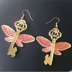 Beautiful flying key earrings with iridescent wings that look different colors as it moves. Hook is made of 14k gold plated sterling silver, so great for sensitive ears. 1.75in long 1.75in wide Pierced Winged Earrings As Gift, Winged Jewelry With Ear Wire For Gifts, Iridescent Wings, Key Earrings, Star Pictures, Earrings Photo, Sensitive Ears, Gold Plated Sterling Silver, Different Colors